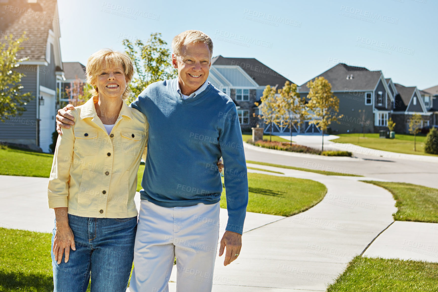 Buy stock photo Shot of a happy senior couple waking around their neighborhood together