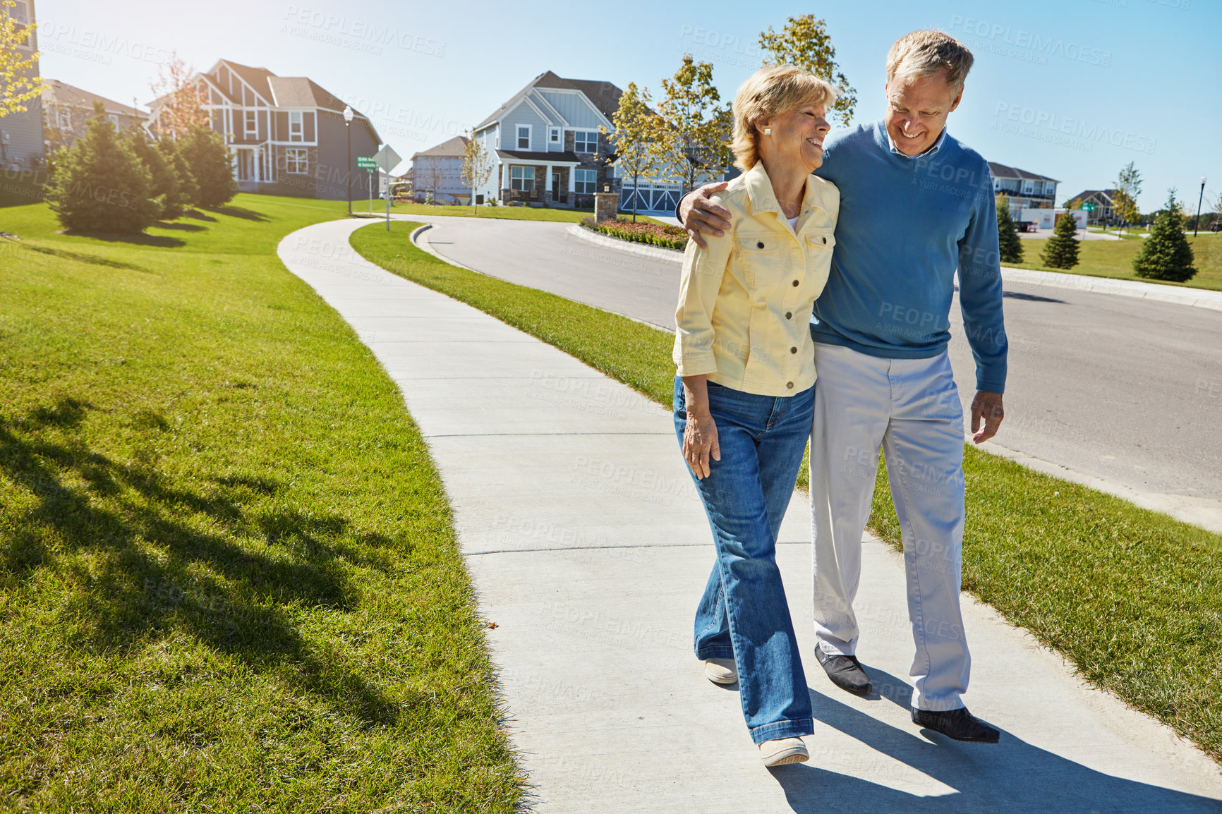 Buy stock photo Shot of a happy senior couple waking around their neighborhood together