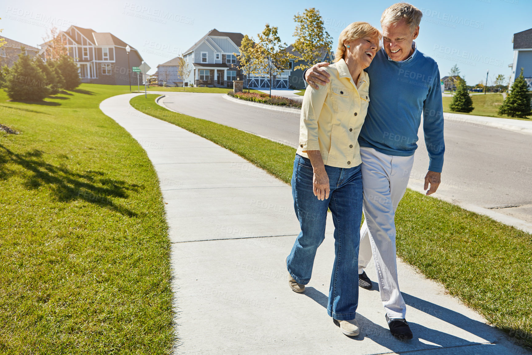 Buy stock photo Shot of a happy senior couple waking around their neighborhood together