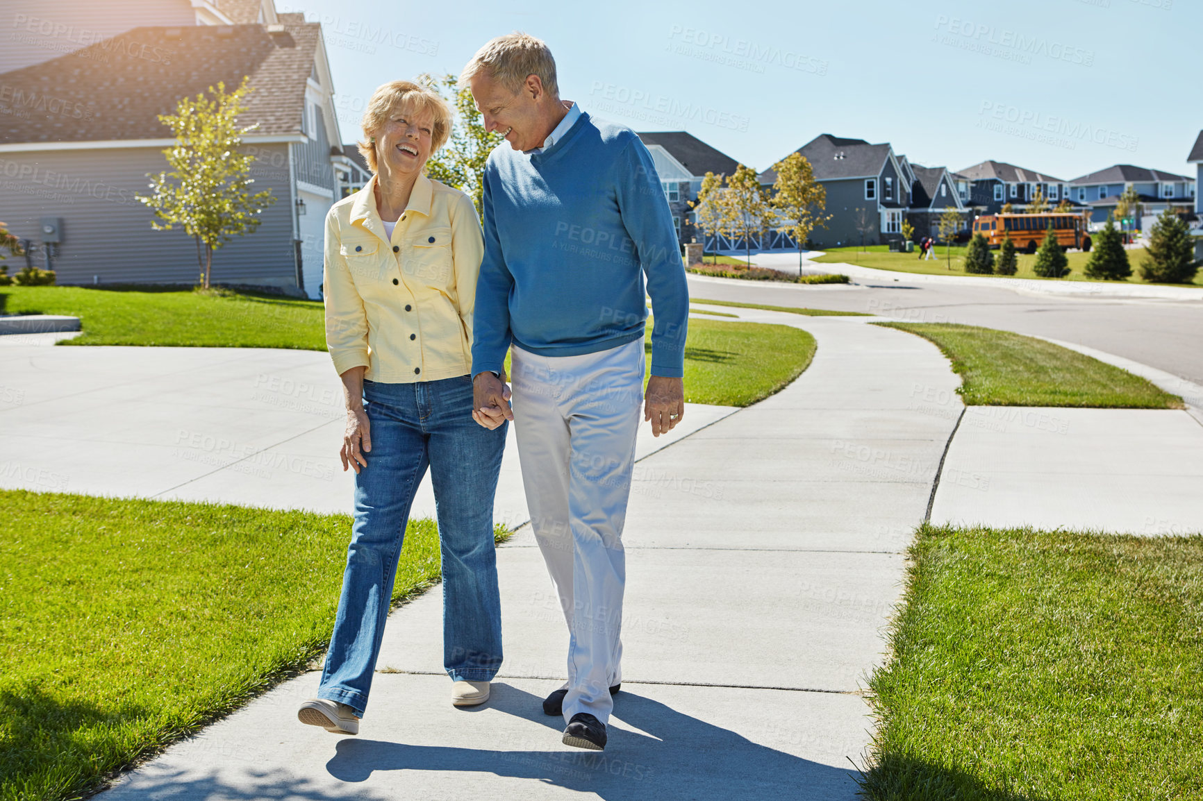 Buy stock photo Shot of a happy senior couple waking around their neighborhood together