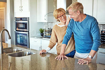 Buy stock photo Mature couple, happy and love in kitchen with trust, support and healthy relationship. Property owners, laugh and comfort at home for bonding, funny storytelling and good joke in Australia with care