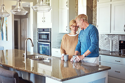 Buy stock photo Mature couple, coffee and love in kitchen with happiness, trust and healthy relationship. Property owners, smile and comfort at home for bonding, morning routine and funny storytelling in Australia