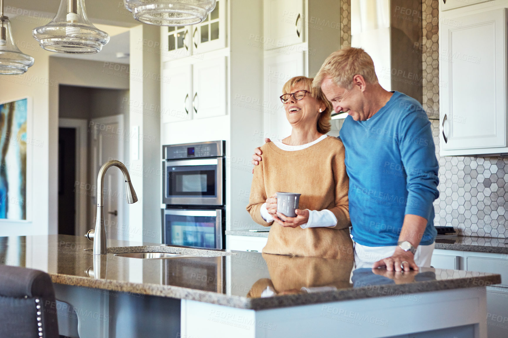 Buy stock photo Cropped shot of a mature couple having coffee in their kitchen