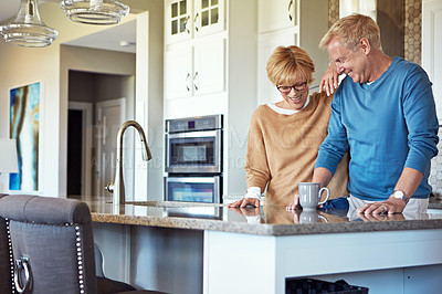 Buy stock photo Cropped shot of a mature couple having coffee in their kitchen