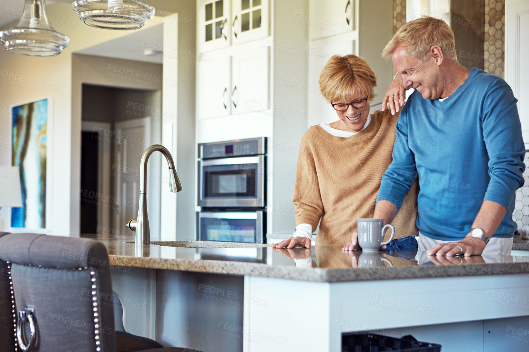 Buy stock photo Cropped shot of a mature couple having coffee in their kitchen