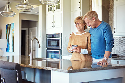 Buy stock photo Cropped shot of a mature couple having coffee in their kitchen