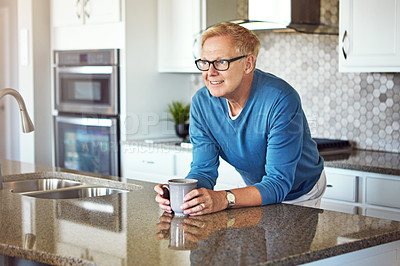 Buy stock photo Cropped shot of a mature man drinking coffee in her kitchen