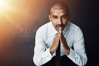 Buy stock photo Studio portrait of a confident young businessman against a dark background