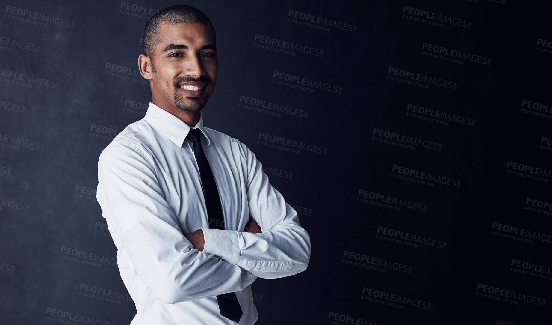 Buy stock photo Studio portrait of a confident young businessman against a dark background