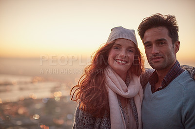 Buy stock photo Portrait of a happy young couple posing in front of a city view