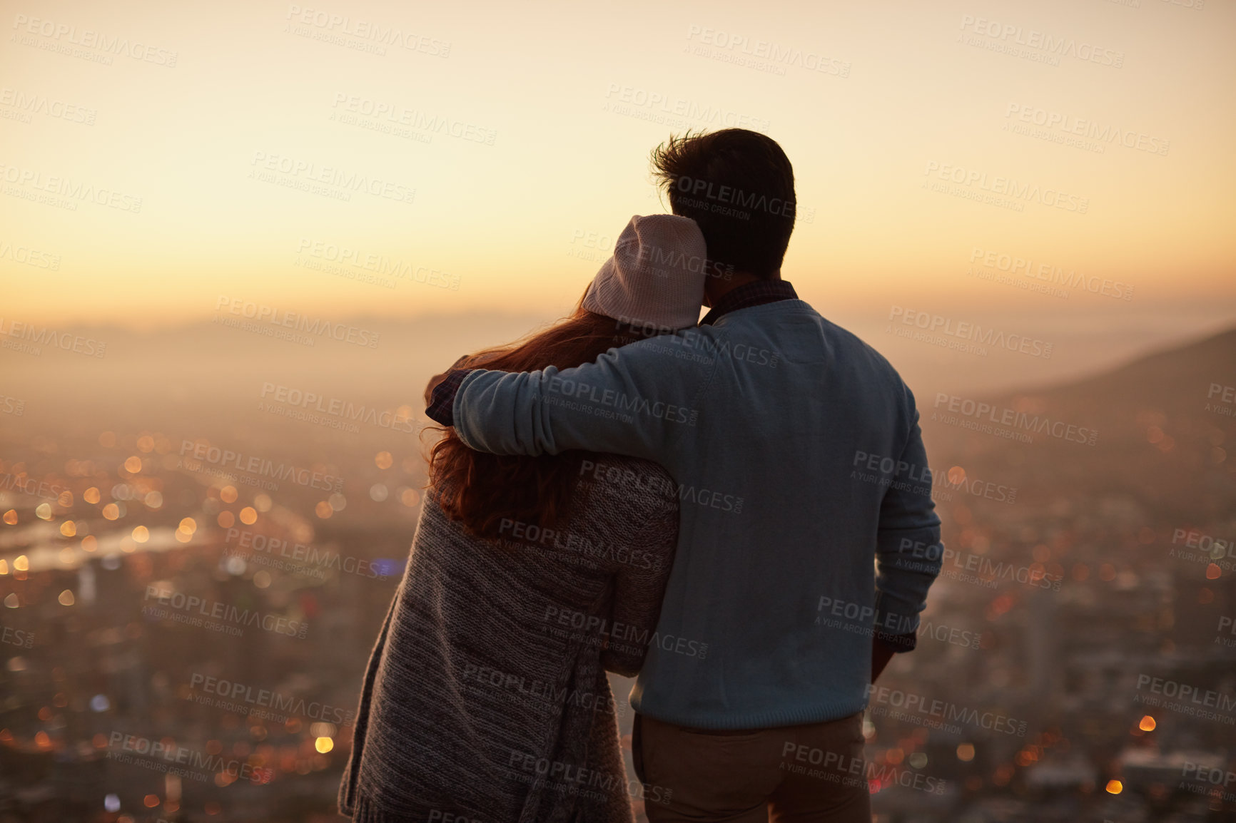 Buy stock photo Couple, back and hug for city view at sunset, outdoor and bonding for love in relationship. People, dusk and embrace for romance on holiday or vacation, travel and relax on mountain for support