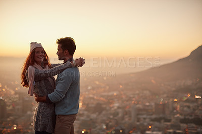 Buy stock photo Couple, date and hug for cityscape sunset, outdoor view and bonding for love in relationship. People, dusk and embrace for romance on holiday or vacation, travel and relax on mountain for scenery