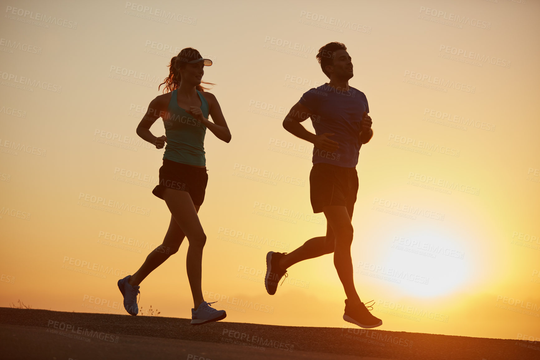 Buy stock photo Sunrise, couple and running with silhouette of race training, exercise and fitness with cardio for health. Wellness, sport and athlete with runner partner in nature together in morning with sprint