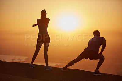 Buy stock photo Shot of a silhouetted couple out for a run at sunrise