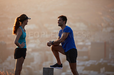 Buy stock photo Shot of an athletic young couple out for a run in the morning