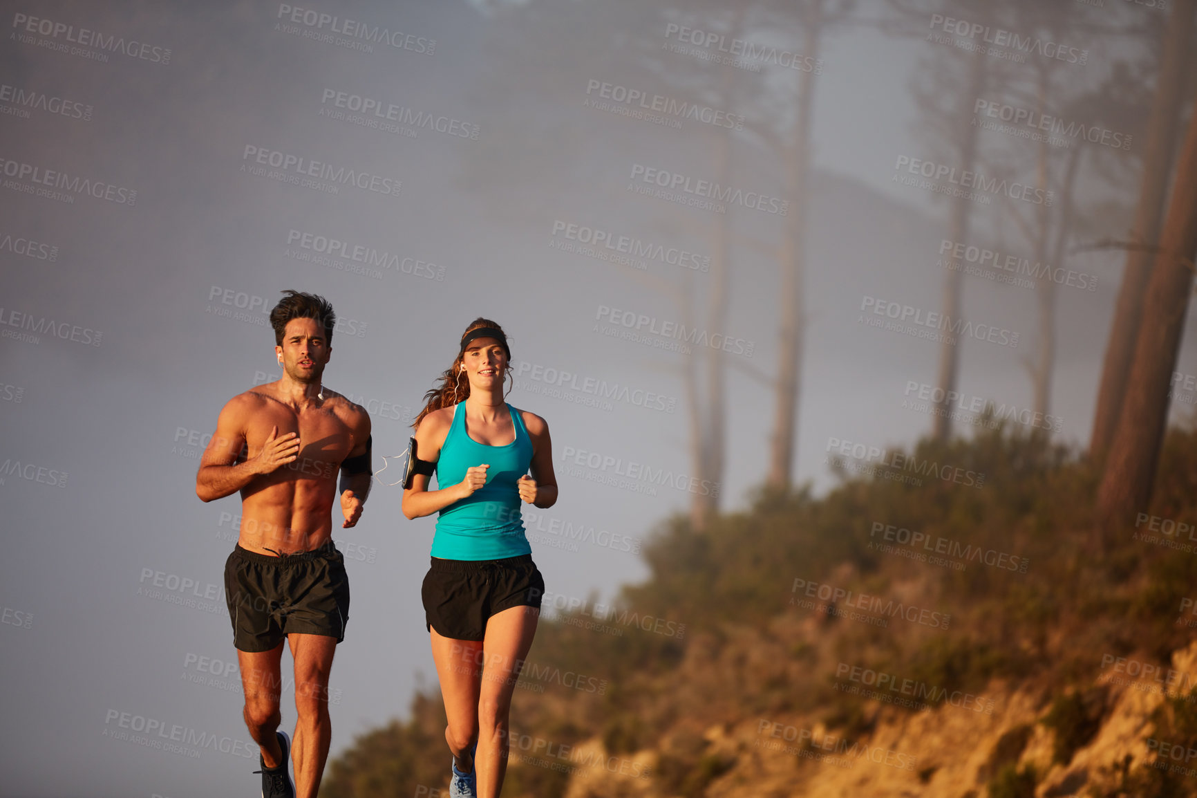 Buy stock photo Couple, running and exercise in outdoor nature, coaching and cardio challenge or marathon training. People, mist and bonding together on jog on mountain road, fitness and sports workout or practice
