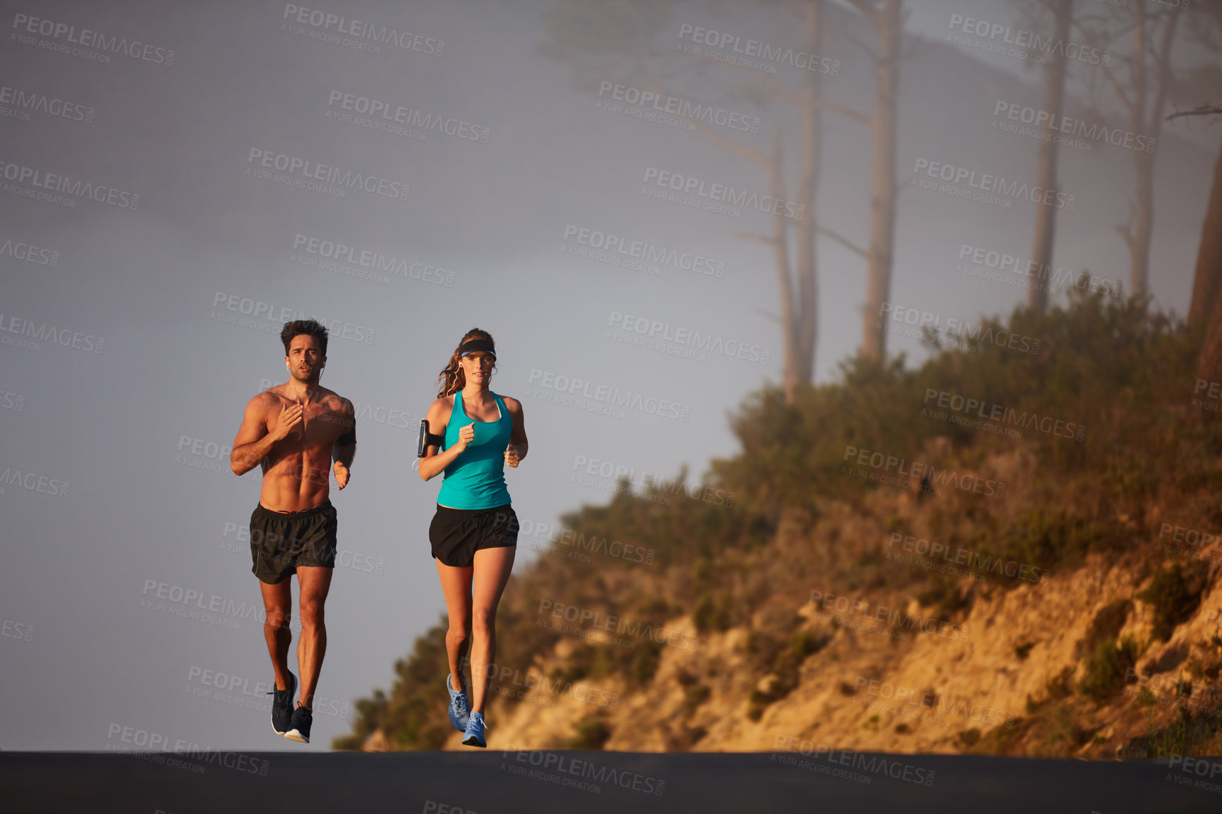 Buy stock photo Couple, running and race in outdoor street, coaching and cardio challenge or marathon training. People, action and bonding together on jog on mountain road, fitness and sports workout or practice