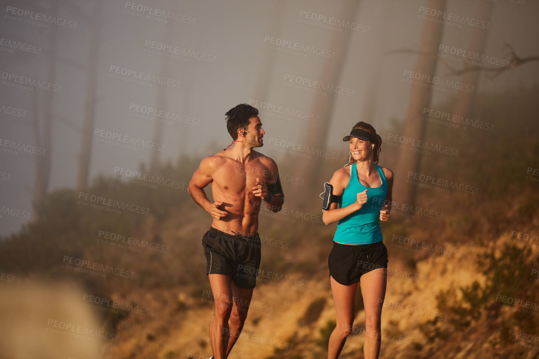 Buy stock photo Shot of an athletic young couple out for a run in the morning