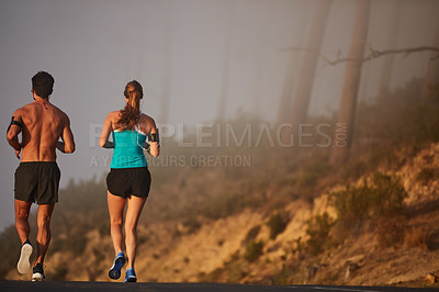 Buy stock photo Couple, running and fitness in outdoor street, coaching and cardio challenge or marathon training. People, action and bonding together on jog on mountain road, back and sports workout or practice