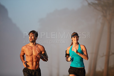 Buy stock photo Couple, running and exercise in outdoor mist, coaching and cardio challenge or marathon training. People, action and bonding together on jog on mountain nature, fitness and sports workout or practice