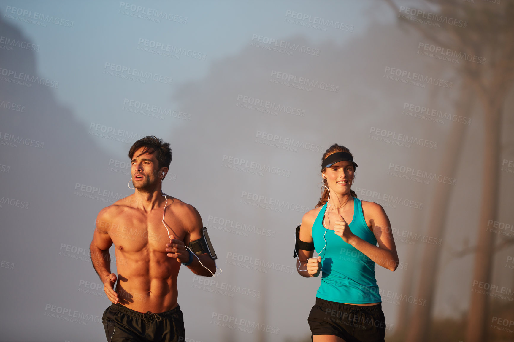 Buy stock photo Couple, running and exercise in outdoor mist, coaching and cardio challenge or marathon training. People, action and bonding together on jog on mountain nature, fitness and sports workout or practice