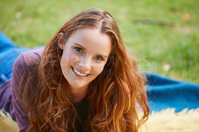 Buy stock photo Shot of a young woman relaxing at the park