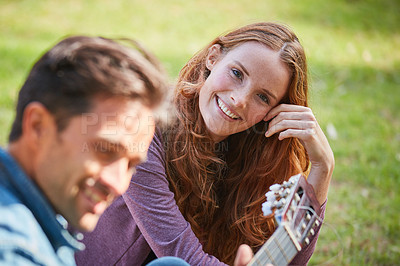 Buy stock photo Shot of a smiling young couple enjoying the day together at the park