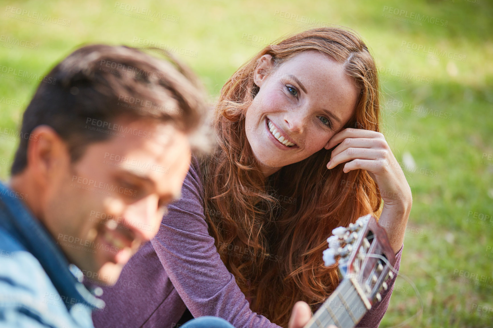 Buy stock photo Shot of a smiling young couple enjoying the day together at the park