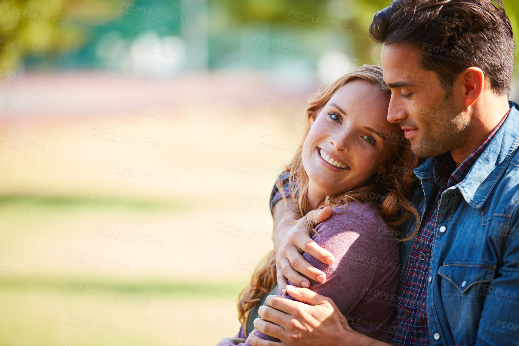 Buy stock photo Shot of a smiling young couple enjoying the day together at the park