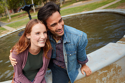 Buy stock photo Shot of a smiling young couple enjoying the day together at the park