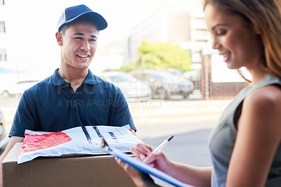 Buy stock photo Cropped shot of a courier making a delivery to a businesswoman