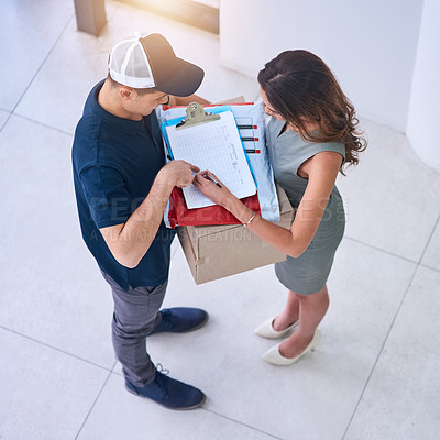 Buy stock photo Shot of a courier making a delivery to a businesswoman in an office
