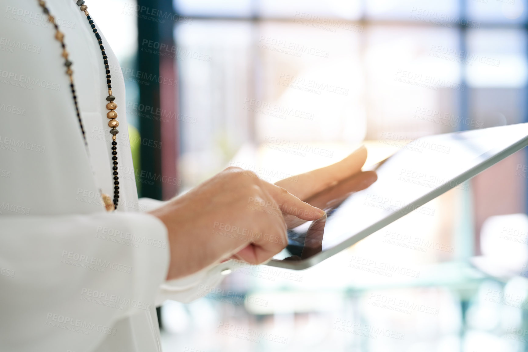 Buy stock photo Cropped shot of a businesswoman using a digital tablet in an office