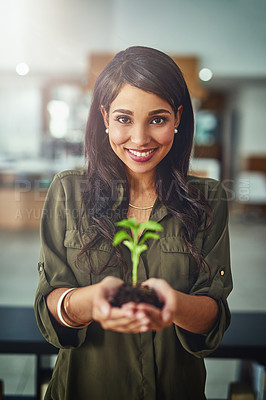 Buy stock photo Portrait of a young businesswoman holding a plant growing in soil