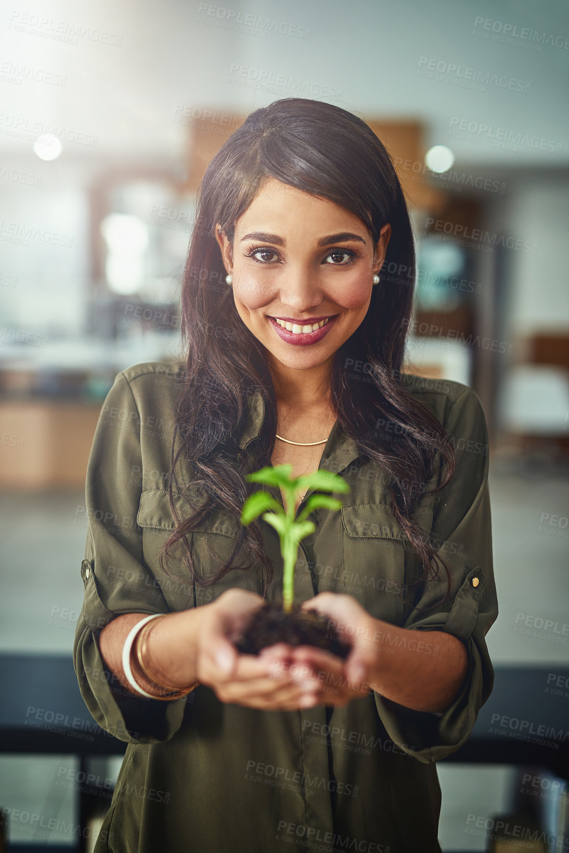 Buy stock photo Portrait of a young businesswoman holding a plant growing in soil