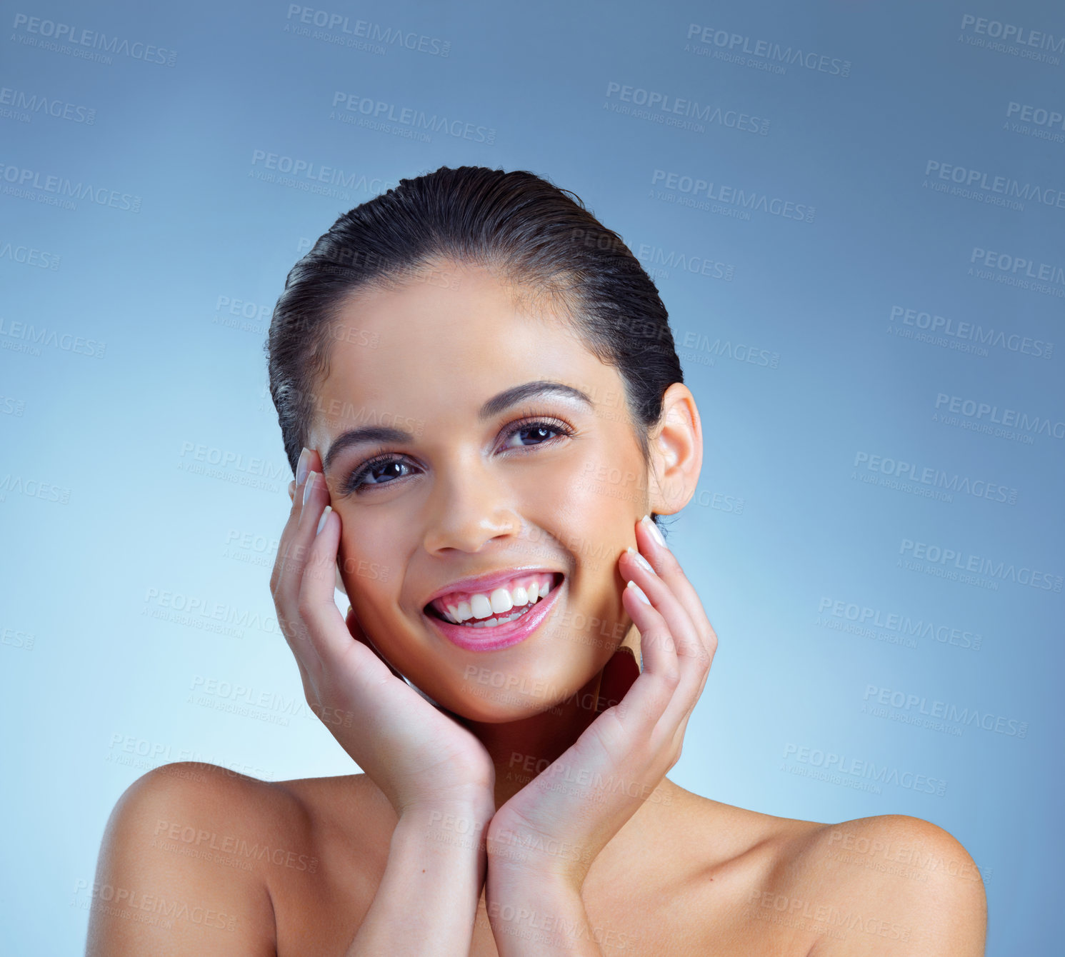 Buy stock photo Studio portrait of a beautiful young woman posing against a blue background