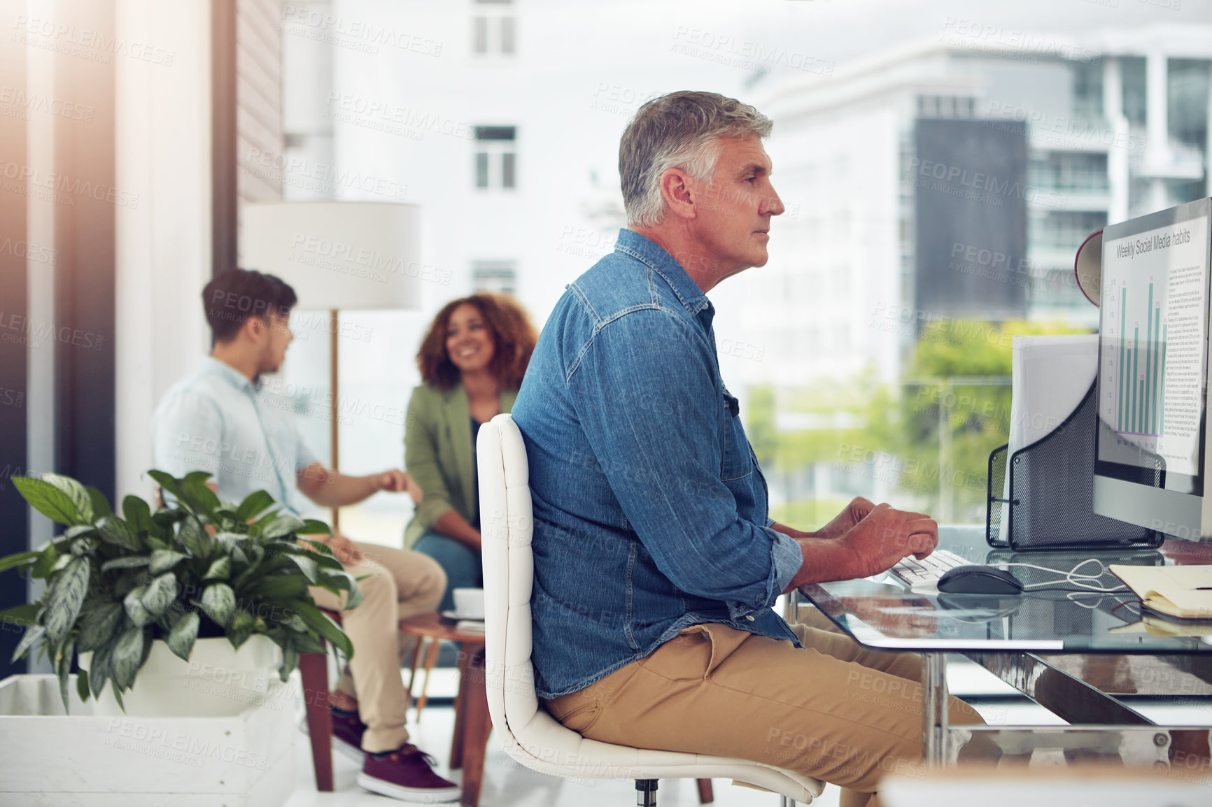 Buy stock photo Cropped shot of a mature businessman working on his designs in the office