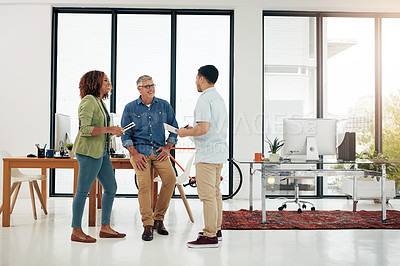 Buy stock photo Full length shot of three creative professionals talking in the office