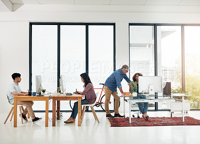 Buy stock photo Full length shot of four designers working in their creative office environment
