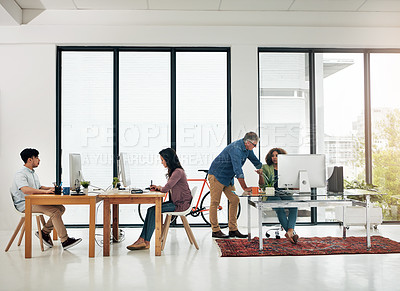 Buy stock photo Full length shot of four designers working in their creative office environment