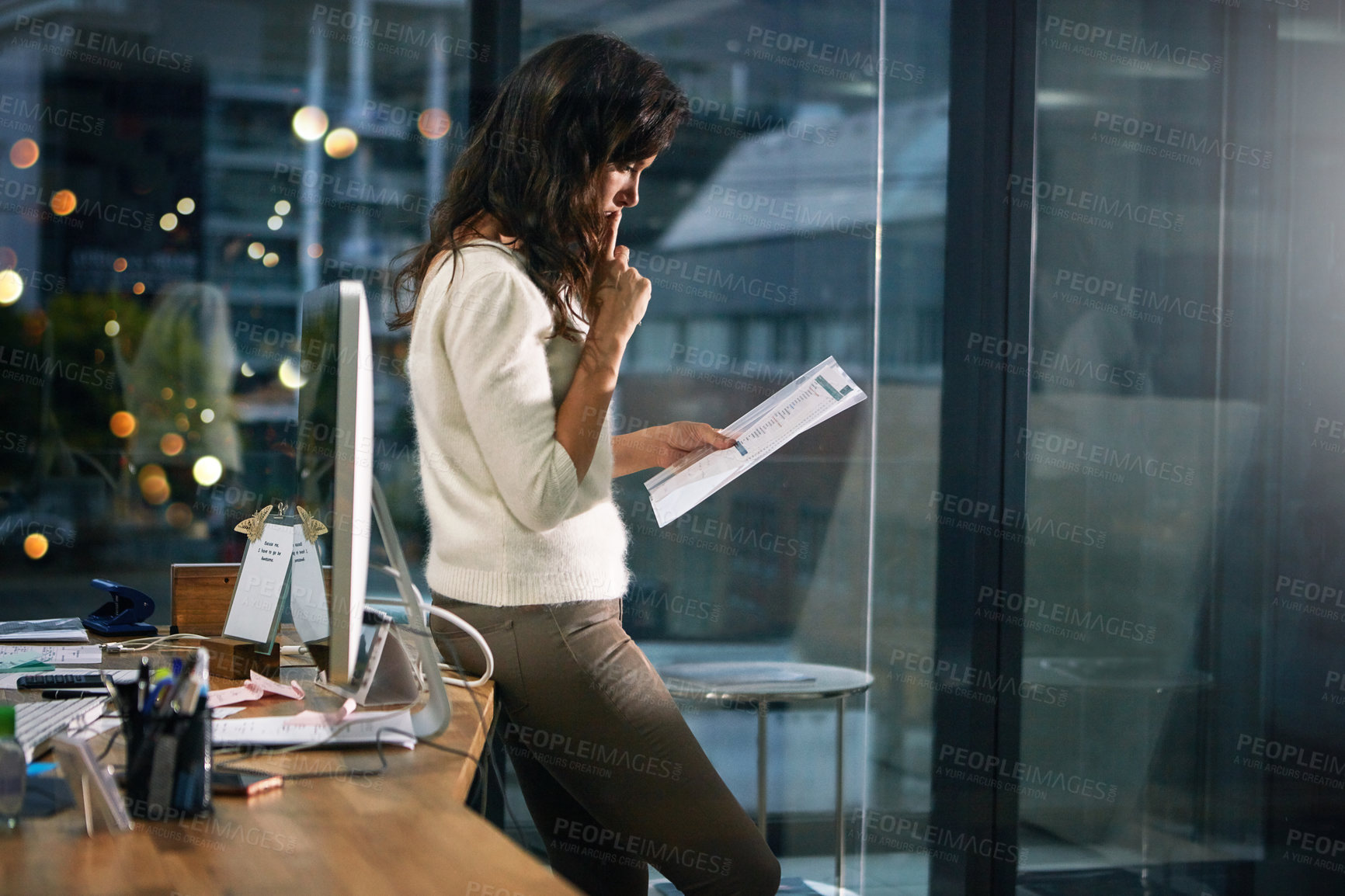 Buy stock photo Shot of a dedicated businesswoman working alone in her office after hours