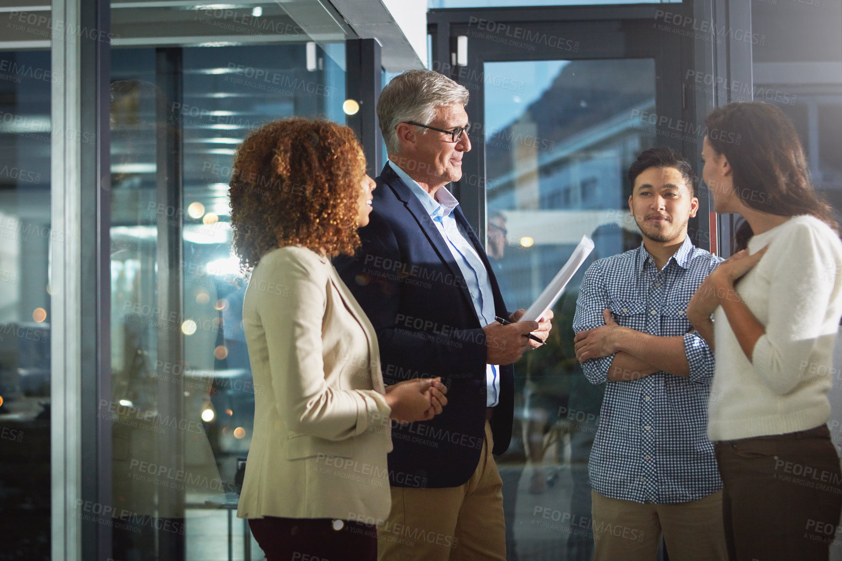 Buy stock photo Shot of a team of dedicated colleagues working together in their office after hours