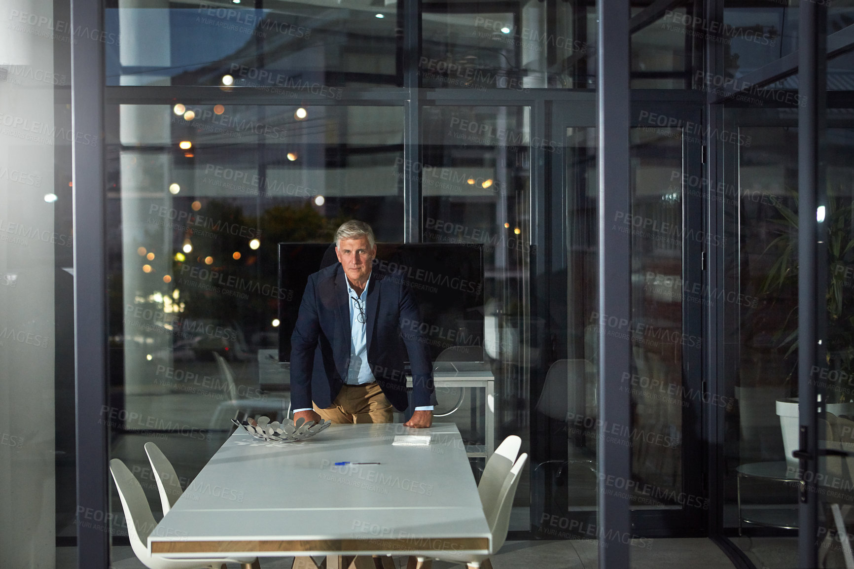 Buy stock photo Portrait of a dedicated businessman working alone in his office after hours