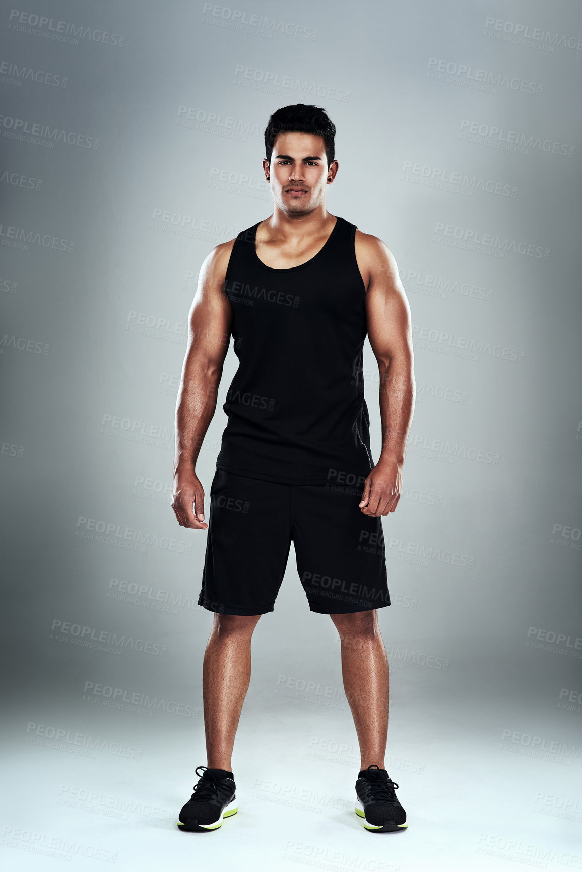 Buy stock photo Full length portrait of a sporty young man standing against a grey background