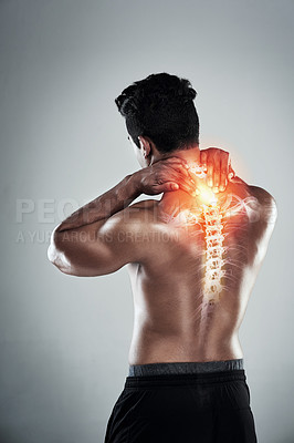 Buy stock photo Rearview shot of a sporty young man holding his neck in pain against a grey background