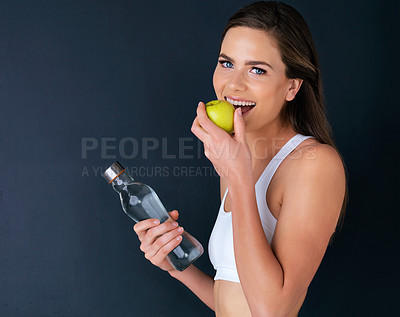 Buy stock photo Happy woman, portrait and diet with apple or water bottle for natural nutrition against a studio background. Female person smile, organic fruit and mineral drink for fitness or lose weight on mockup