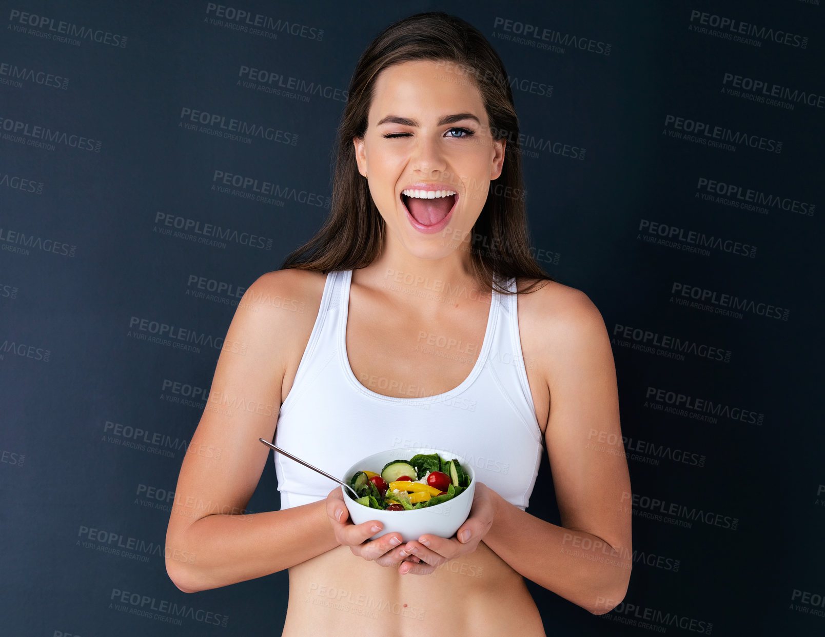 Buy stock photo Happy woman, portrait and wink with salad for diet, lose weight or natural nutrition against a studio background. Female person or model with bowl of vegetables for food or healthy meal on mockup