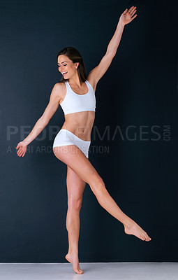 Buy stock photo Happy woman, body and underwear in relax for health, weight loss or fitness against a studio background. Attractive female person, athlete or model smile in slim, lean figure or diet and wellness