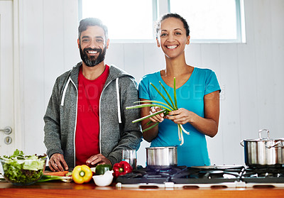 Buy stock photo Portrait of a happy couple cooking together in their kitchen at home