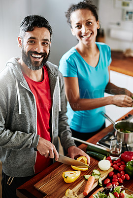 Buy stock photo Portrait of a happy couple cooking together in their kitchen at home